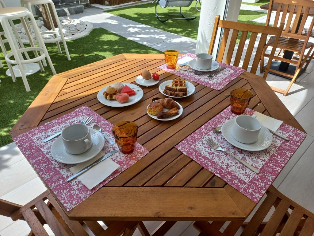 a wooden table with plates of food on it at Casa Dona Antonia - Monsaraz in Monsaraz