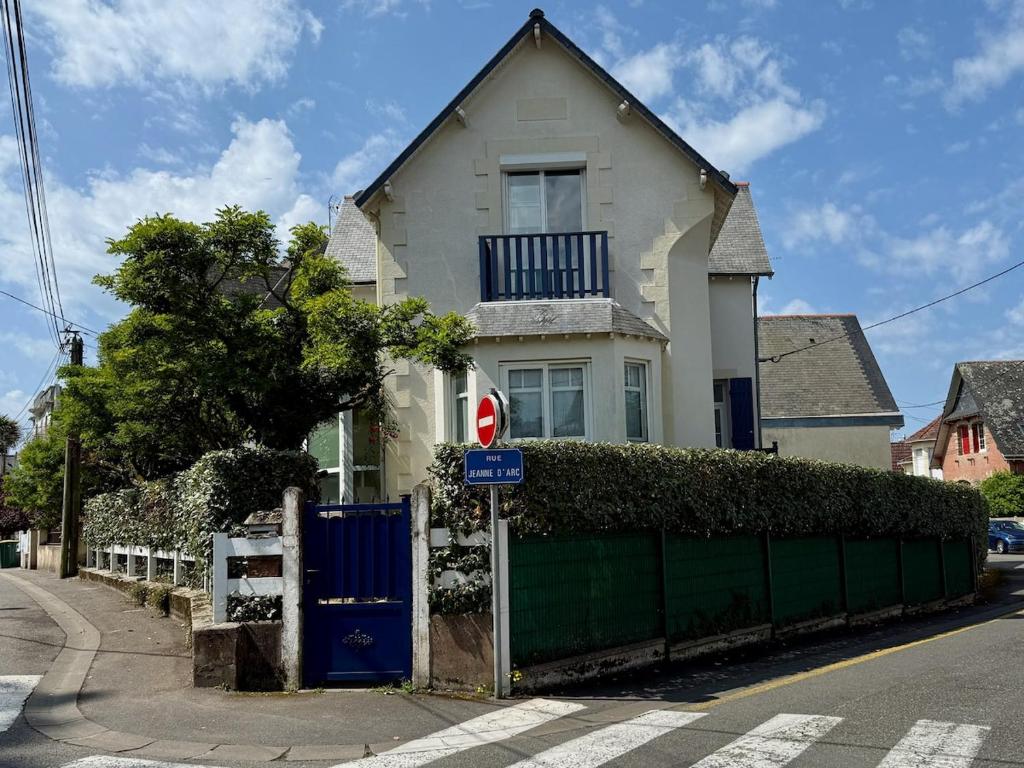 a white house with a blue gate and a fence at Les Lutins Villa Le Pouliguen in Le Pouliguen