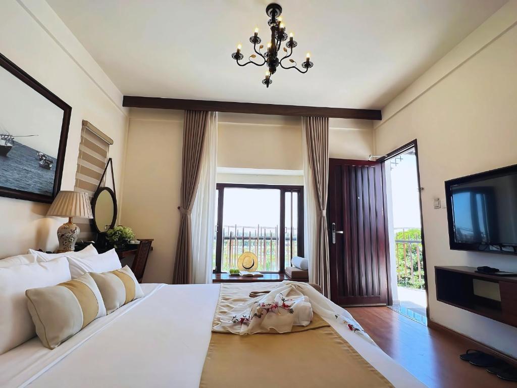 Postel nebo postele na pokoji v ubytování Happy Life Memories Hoi An Hotel & Spa