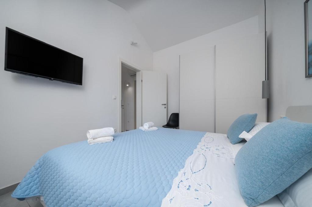 Postel nebo postele na pokoji v ubytování Apartmani Miranda