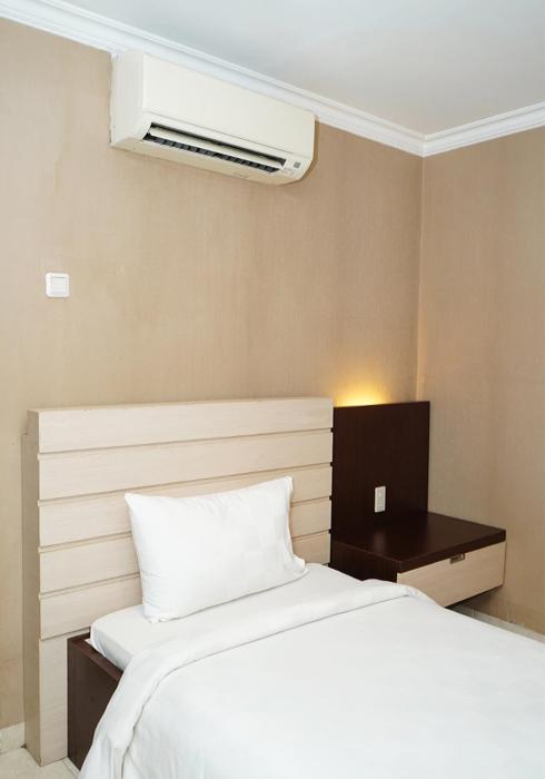 Postel nebo postele na pokoji v ubytování Travellers Suites Serviced Apartments