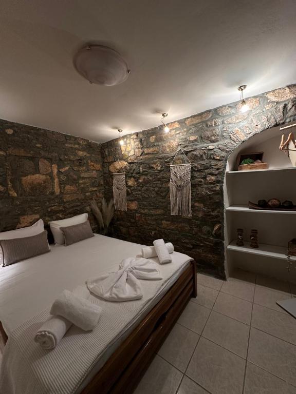 a bedroom with a bed with towels on it at Sidirounta Village Apartment in Sidiroúnta