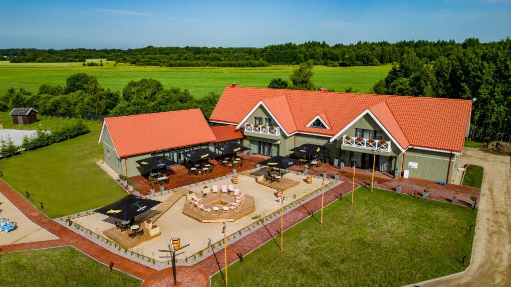 an aerial view of a house with a patio at Viešbutis - restoranas SAKAI in Gribžiniai