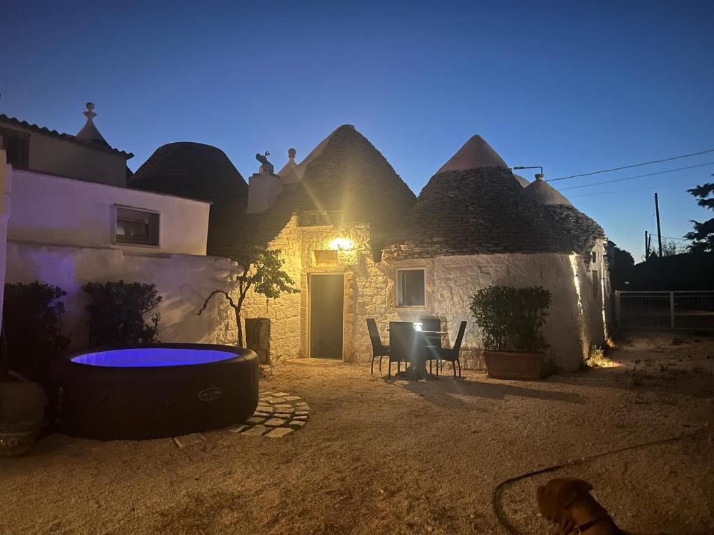 a patio of a house with a table and chairs at Milura Home - con vasca idromassaggi in Locorotondo
