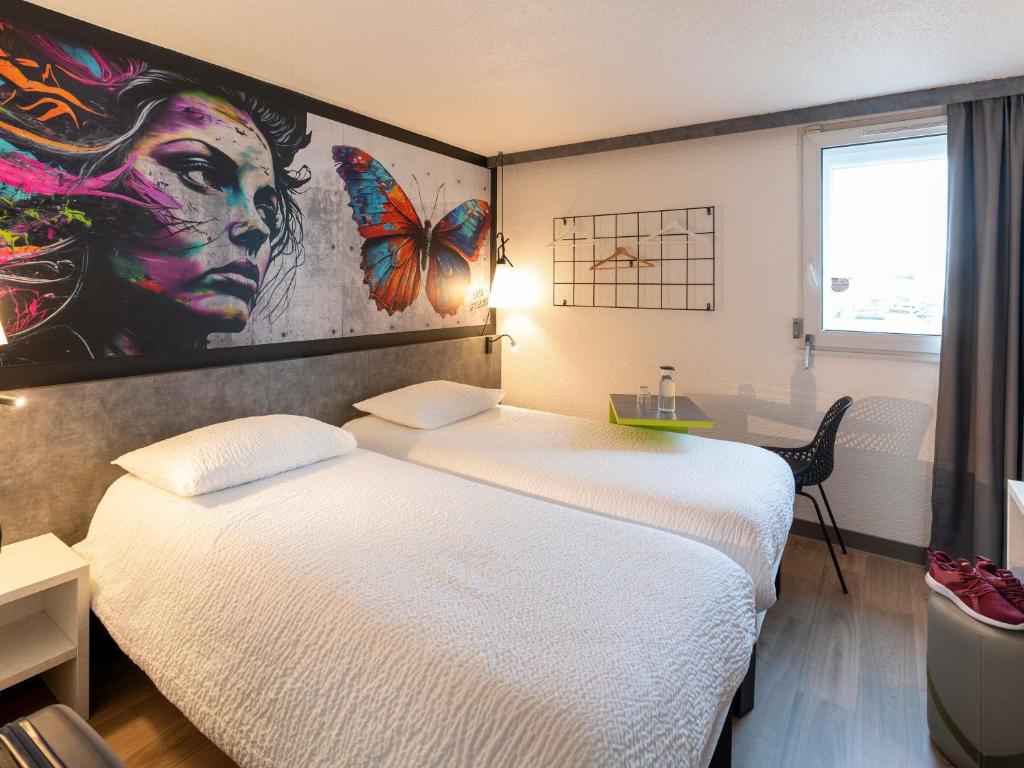 Postel nebo postele na pokoji v ubytování ibis styles Brive Ouest