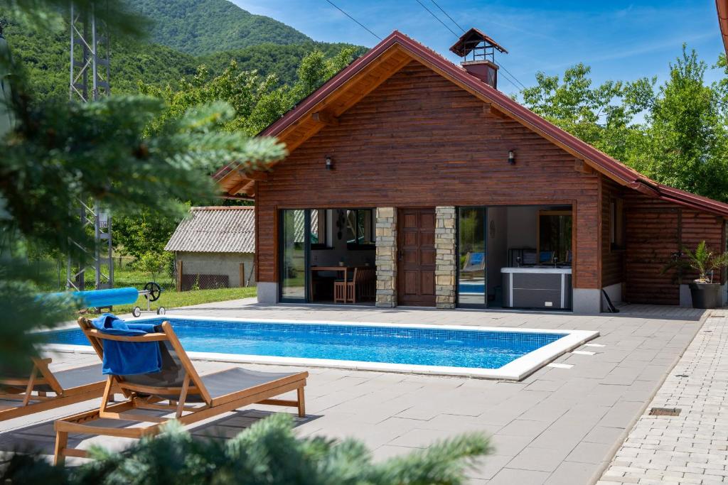 a villa with a pool and a house at Villa Brusiana with heated pool in Brušane