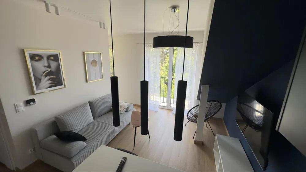 a living room with a couch and a table at Apartament Kwiatkowskiego, self check-in, parking in Rzeszów