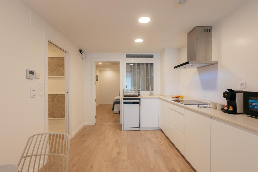 a kitchen with white cabinets and a counter top at Doce de Colón C in Requena