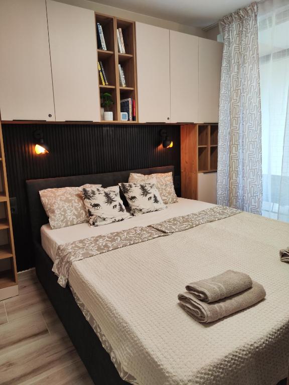 a bedroom with a large bed with towels on it at Студио Sand, к-с Нестинарка in Tsarevo