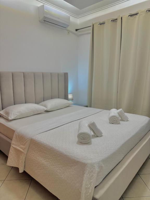 a bedroom with a bed with towels on it at Larissa city ap 7 with parking in Larisa