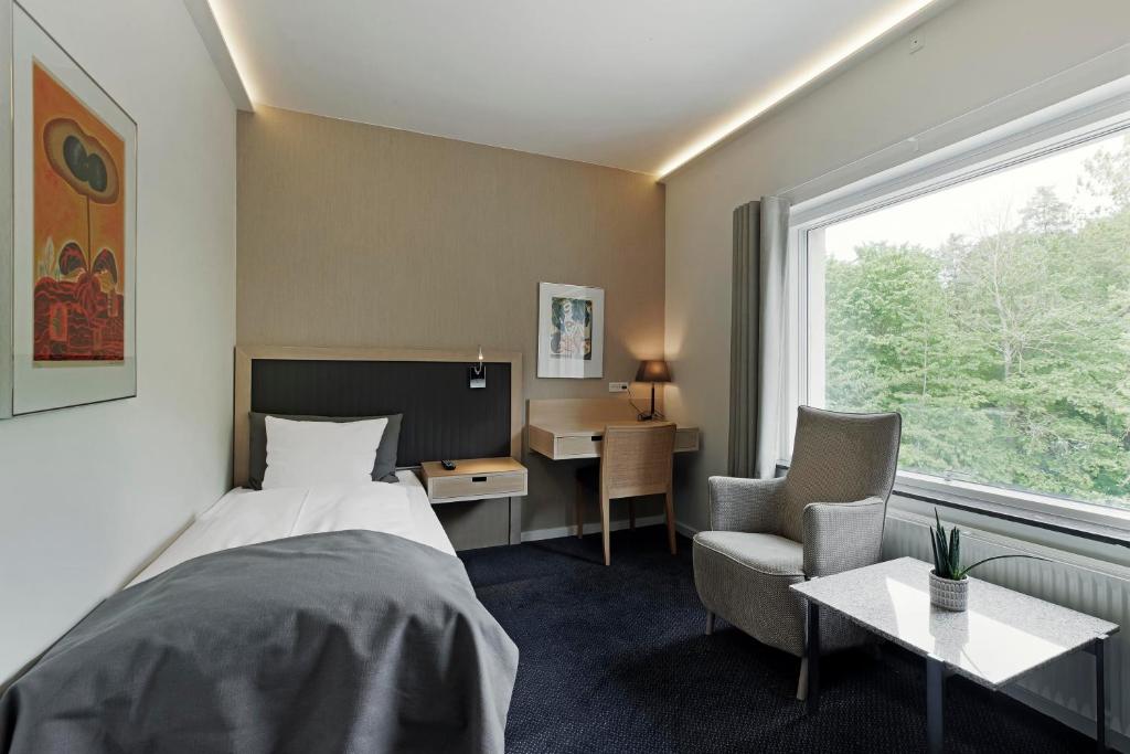 Postel nebo postele na pokoji v ubytování Frederiksdal Sinatur Hotel & Konference