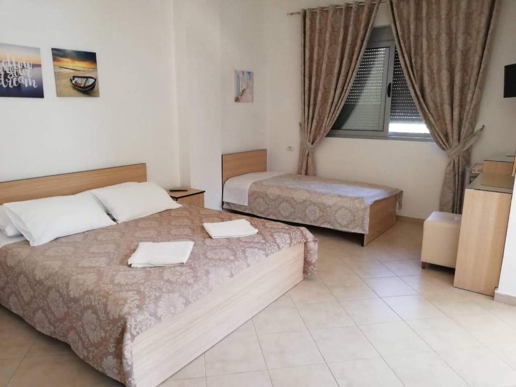 Postel nebo postele na pokoji v ubytování Ilion Hotel