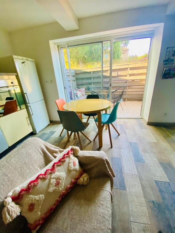 a bedroom with a table and a table and chairs at Maison de Village in Canet d'Aude