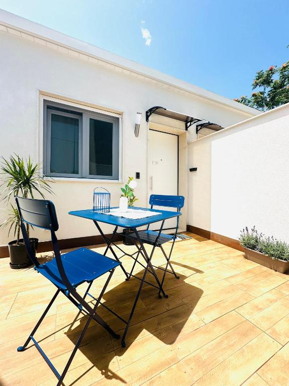a patio with two chairs and a table on a deck at La MAISON D'ISABELLE in Bari