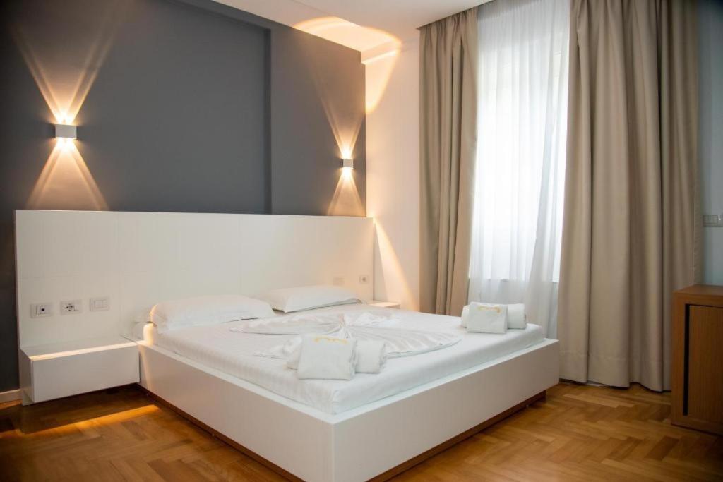 Postel nebo postele na pokoji v ubytování Thea Hotel