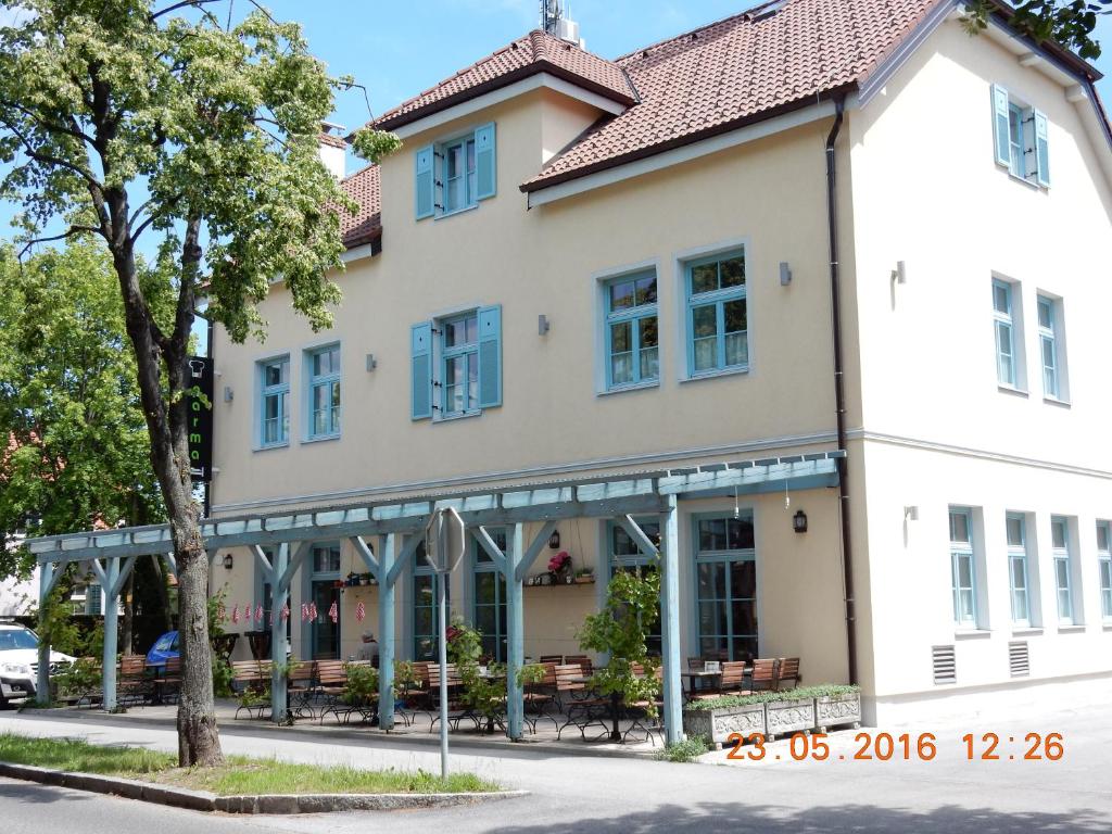 a large white building with blue windows at Guest House Parma in Maribor