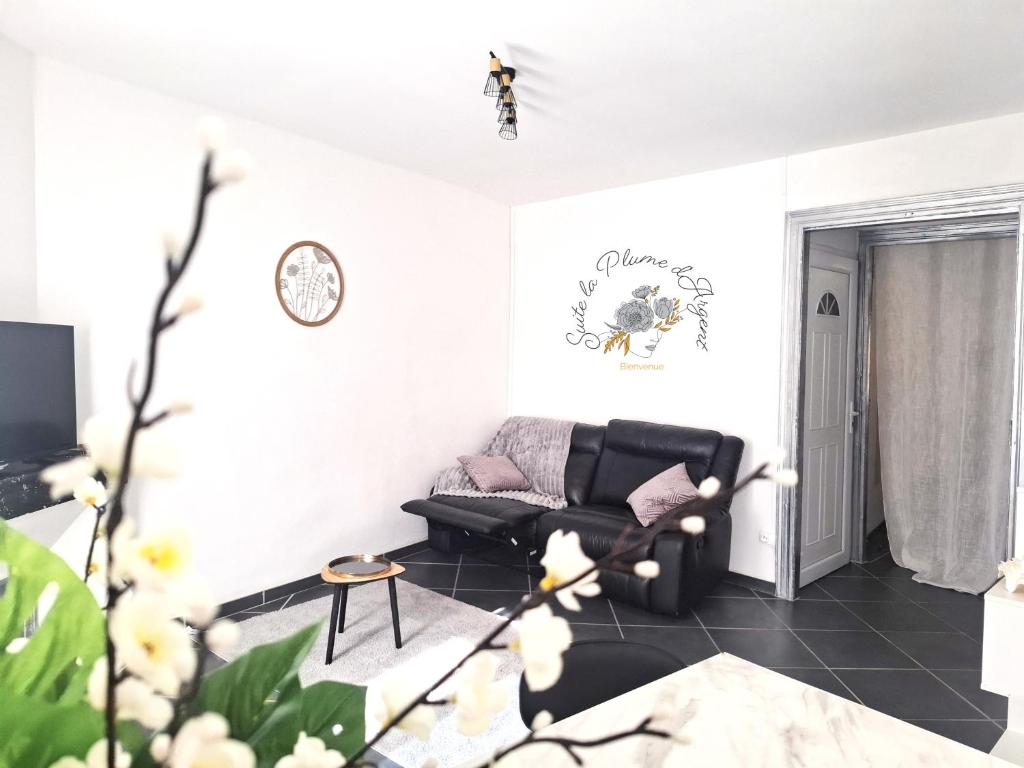 a living room with a couch and a table at Suite la Plume d'Argent in Bédarieux