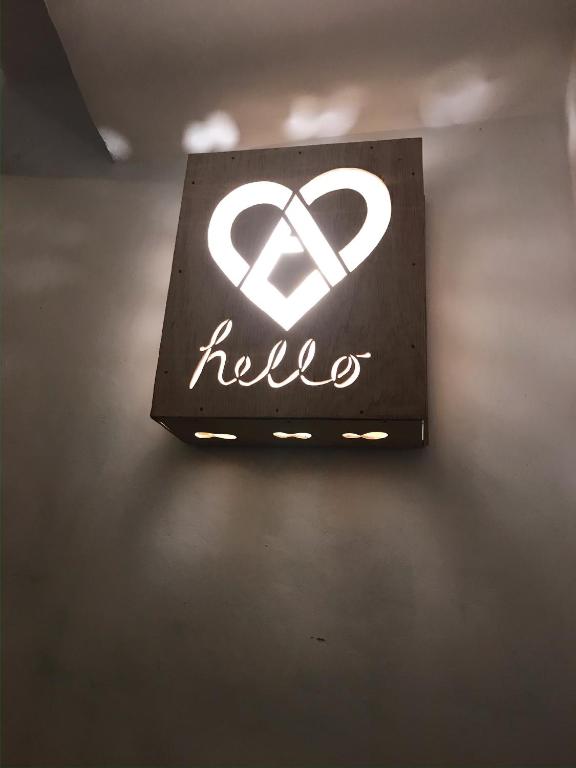 a sign with the word hello hanging on a wall at Casa del Rellotge in Benifallet