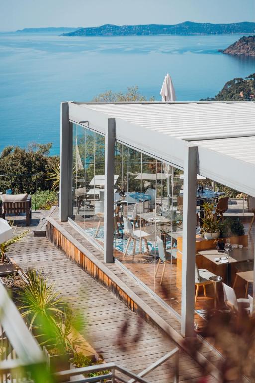 a view of the ocean from the deck of a restaurant at Hôtel La Villa Douce in Rayol-Canadel-sur-Mer
