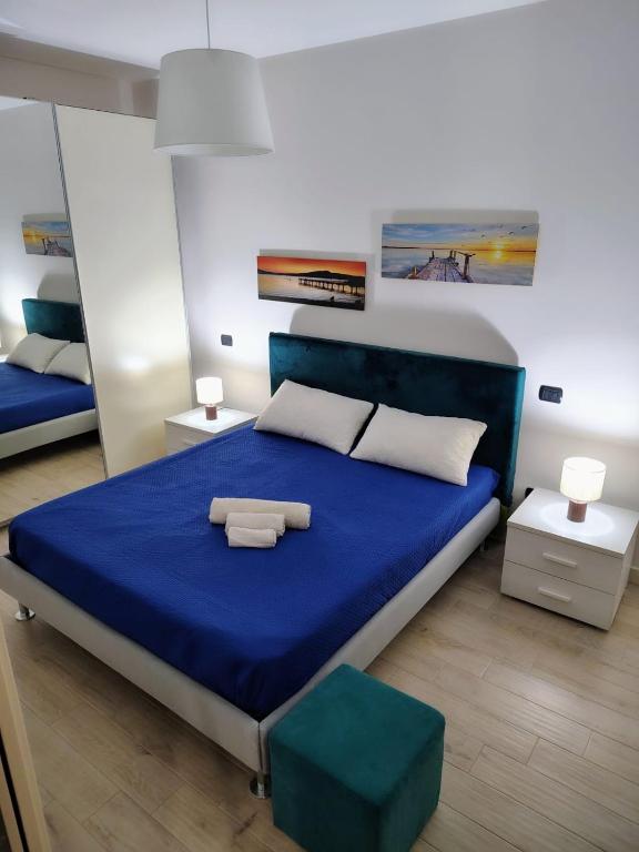 a bedroom with a blue bed with two towels on it at mono polis apartment in Monopoli