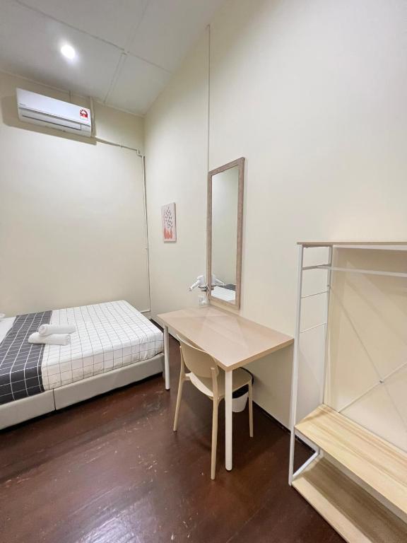 a room with a bed and a table and a mirror at myROOM @ Mandalay Georgetown, Off Jln Burma, Gurney Drive in George Town