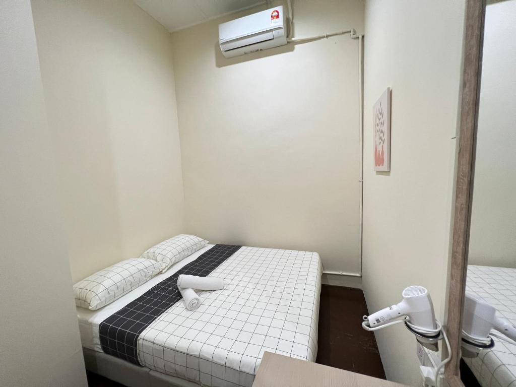 a small room with two beds and a heater at myROOM @ Mandalay Georgetown, Off Jln Burma, Gurney Drive in George Town