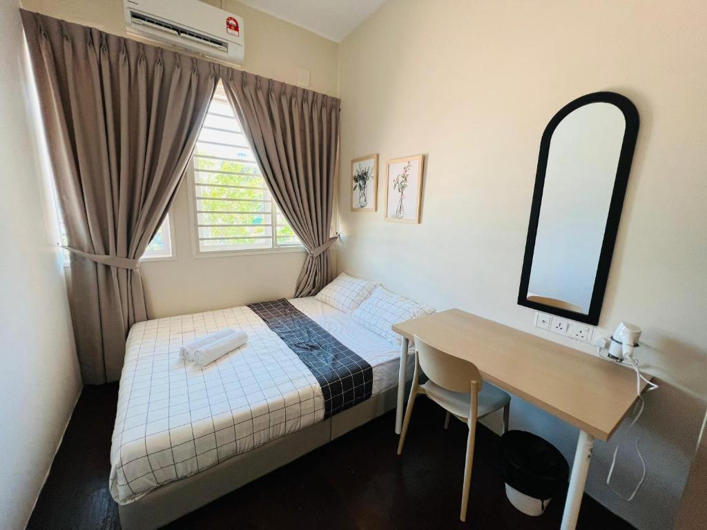 a small bedroom with a bed and a desk at myROOM @ Mandalay Georgetown, Off Jln Burma, Gurney Drive in George Town