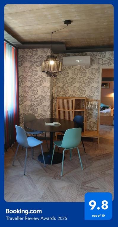a dining room with a table and two chairs at Blonde River Apartman Móra Szeged in Szeged