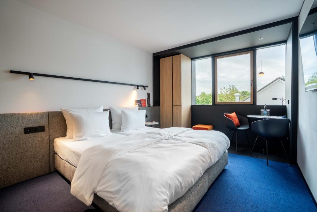 Postel nebo postele na pokoji v ubytování GREFIS Hotel