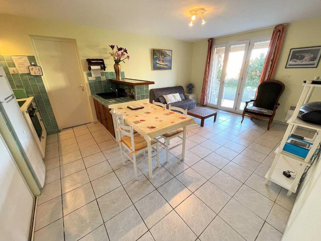 une cuisine et un salon avec une table et des chaises dans l'établissement Bas de villa proche de toute commodités, à Saint-Mandrier-sur-Mer