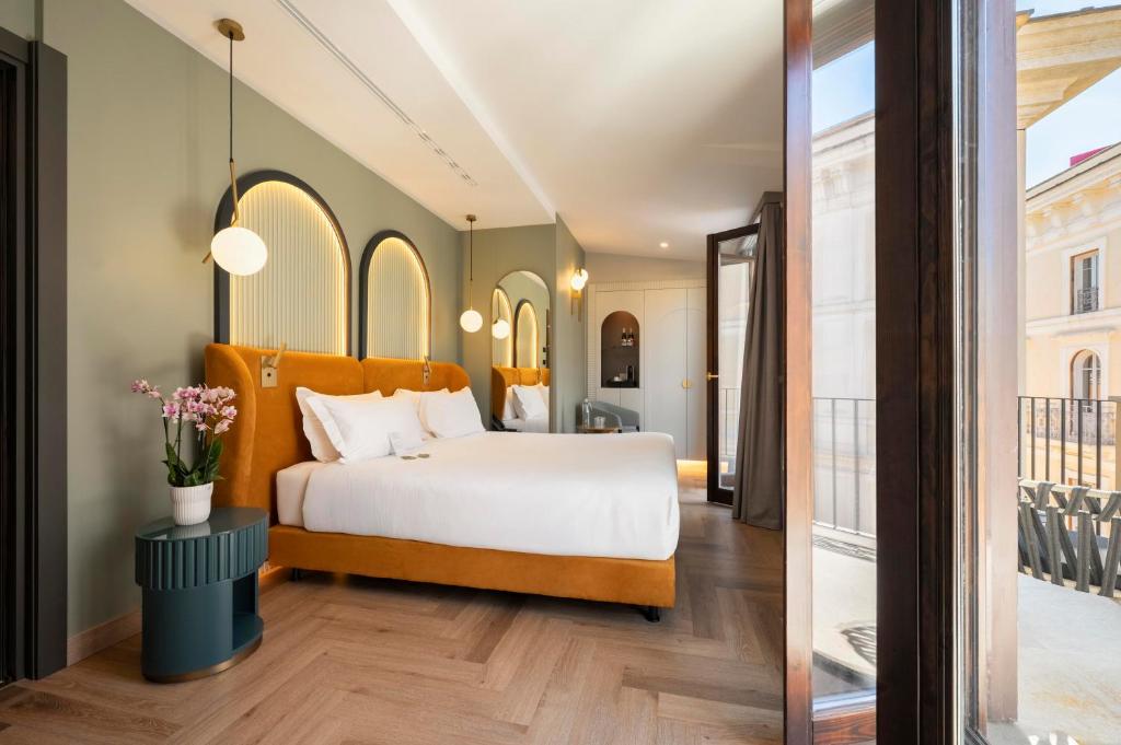 Postel nebo postele na pokoji v ubytování Je Rome Hotel