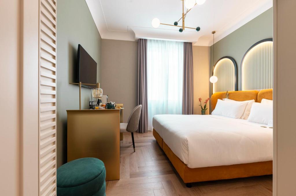 Postel nebo postele na pokoji v ubytování Je Rome Hotel