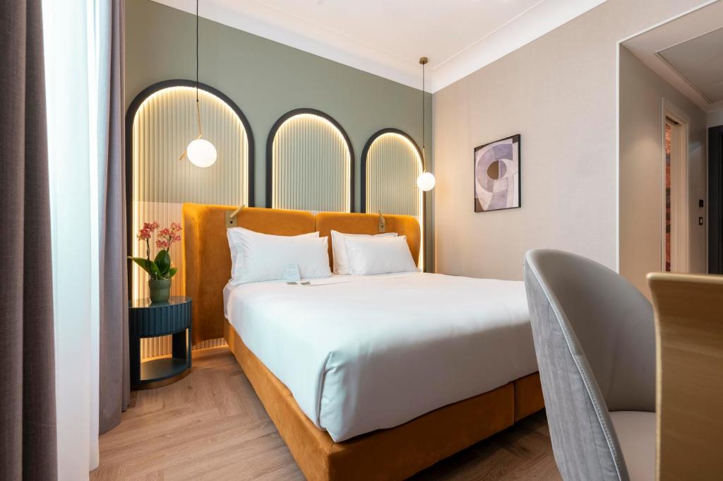 Postel nebo postele na pokoji v ubytování Je Rome Hotel