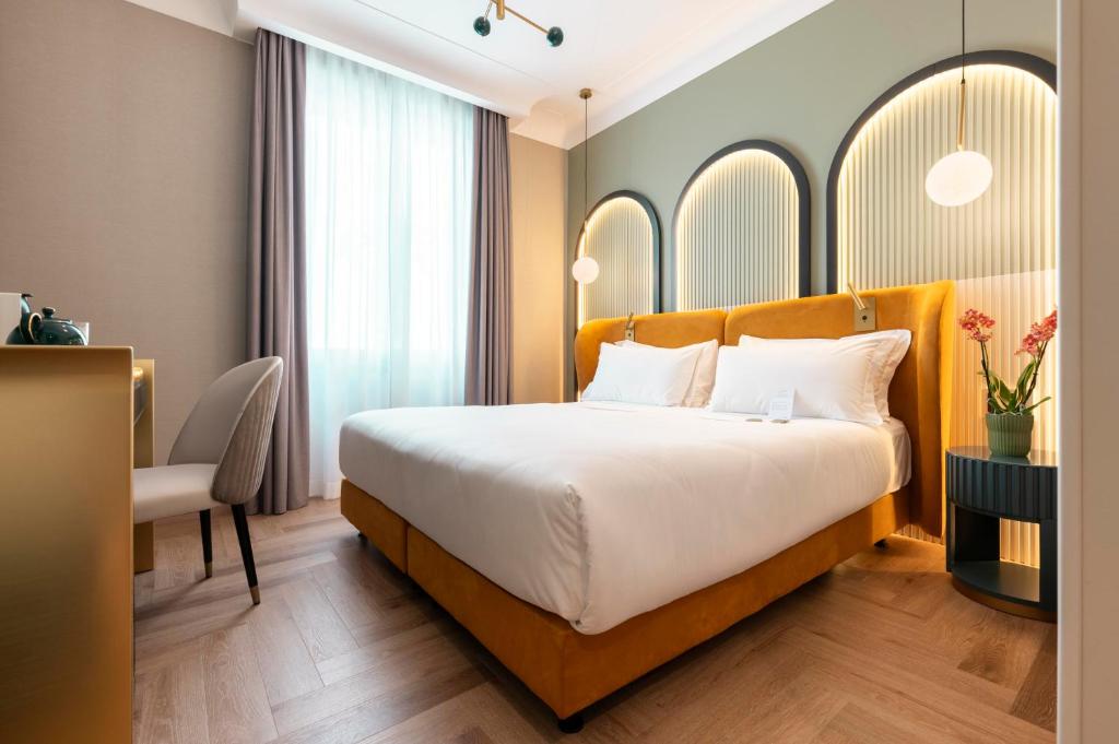 Postel nebo postele na pokoji v ubytování Je Rome Hotel
