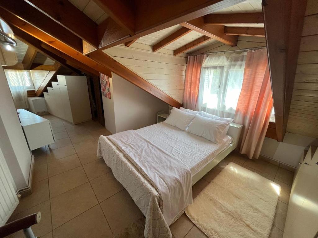 a bedroom with a bed in a wooden room at Litsa's Central Apartments in Agios Rokkos