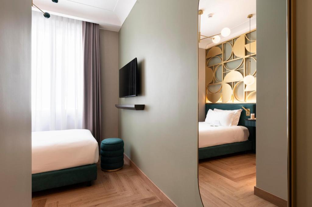 Postel nebo postele na pokoji v ubytování Je Rome Hotel