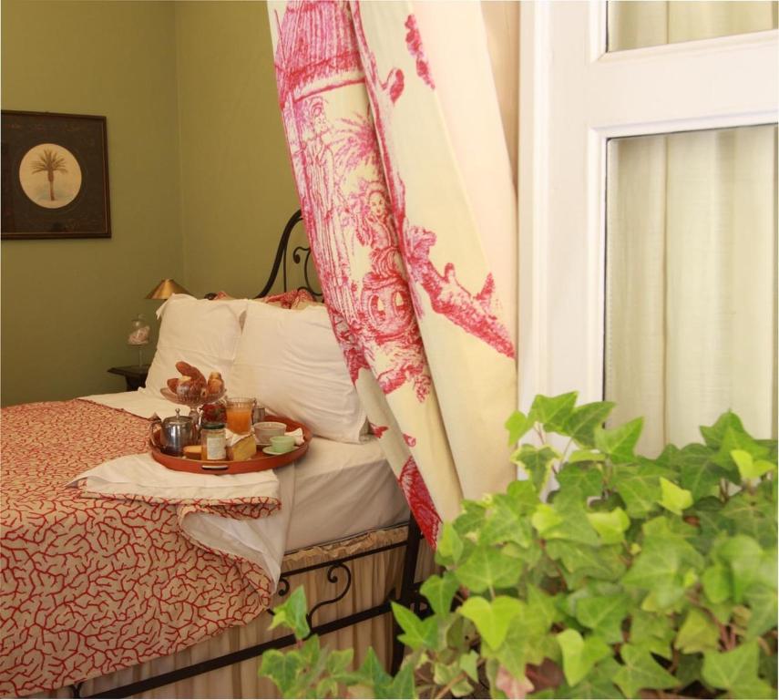 a bedroom with a bed with a table and a window at Casa Dellatorre in Alba