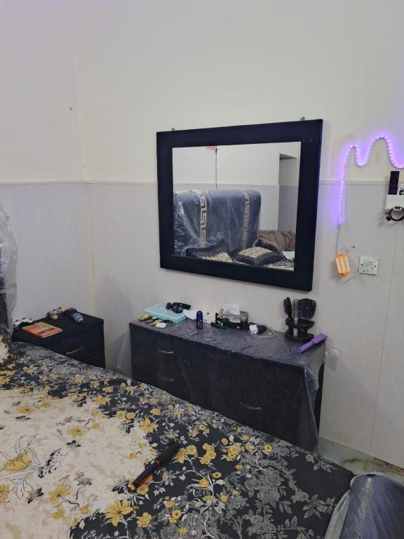 a bedroom with a bed and a mirror on the wall at HEAVEN House in Dargai
