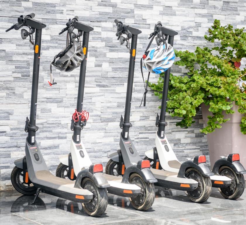a row of scooters parked next to a wall at Bellini Hotel in Ayia Napa