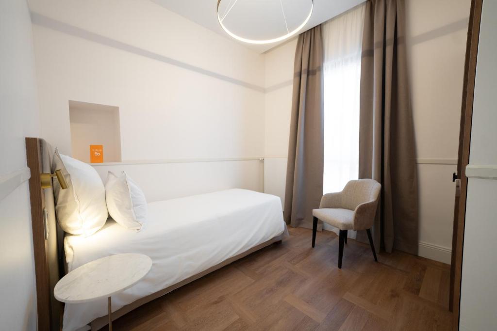 Postel nebo postele na pokoji v ubytování Hôtel Margaux