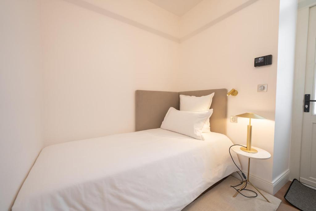 Postel nebo postele na pokoji v ubytování Hôtel Margaux