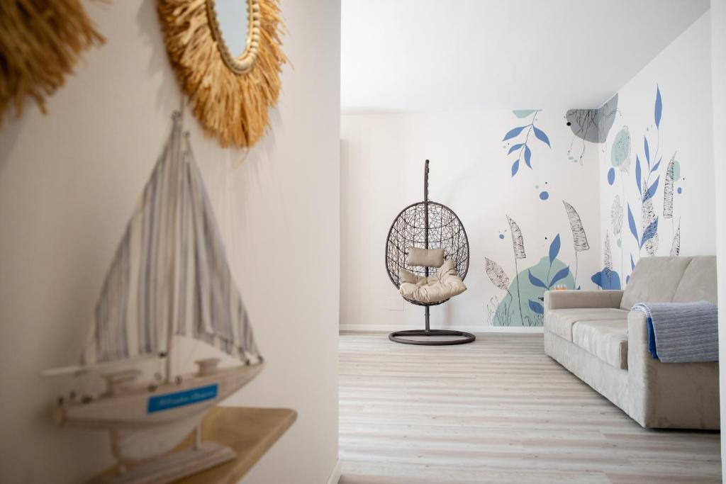 a living room with a couch and a model boat on the wall at Il Confine Azzurro in Porto SantʼElpidio