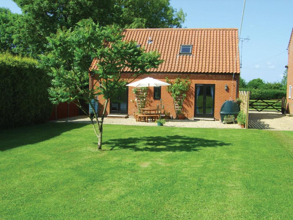 a small tree in the yard of a house at High Farm Barn in Brisley