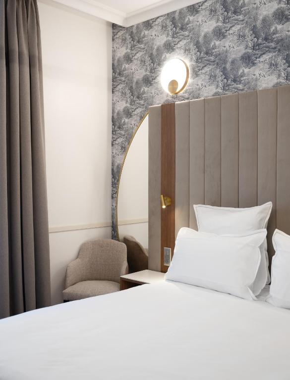Postel nebo postele na pokoji v ubytování Hôtel Margaux