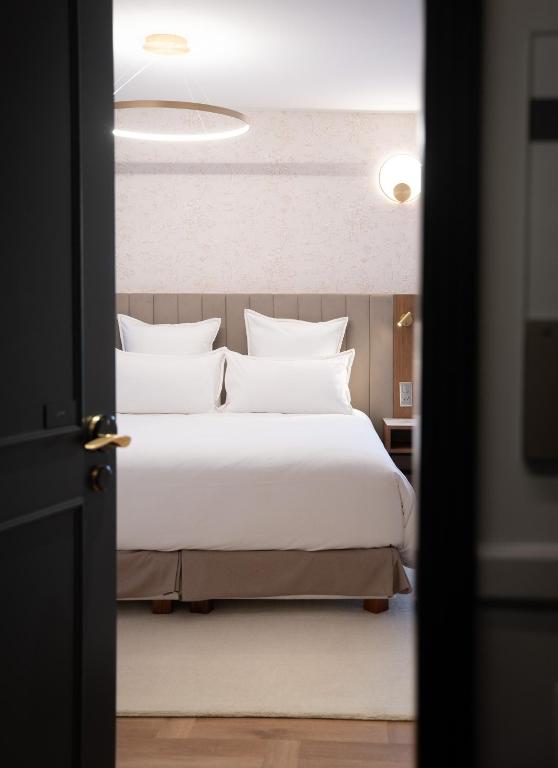 Postel nebo postele na pokoji v ubytování Hôtel Margaux