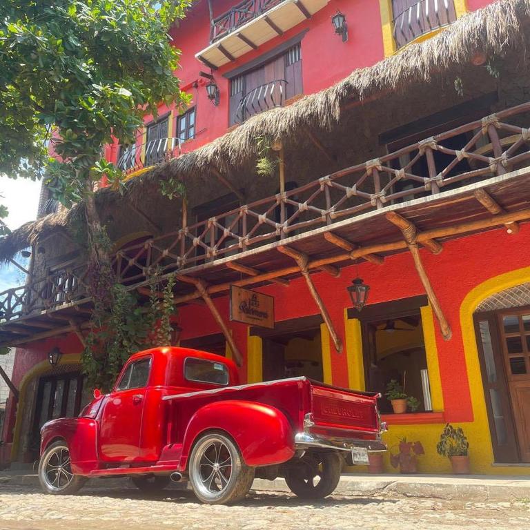 a red truck parked in front of a building at Hotel Artesanal Palomera in San Francisco