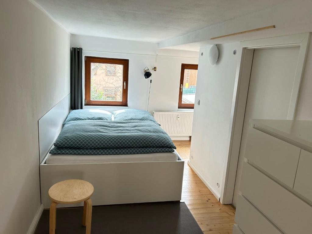 a bedroom with a bed and a chair in it at Apartment Pension Sternchen in Erfurt
