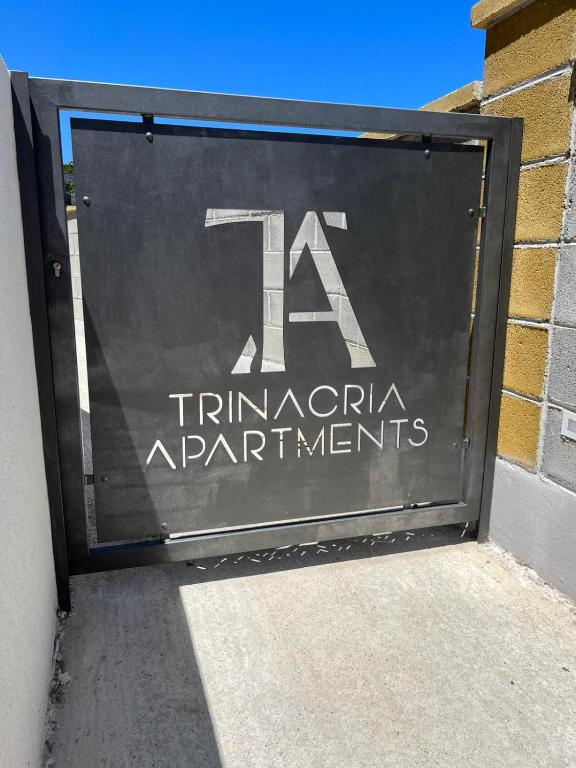 a garage door with a sign on the side of a building at Trinacria apartments Falcone in Falcone