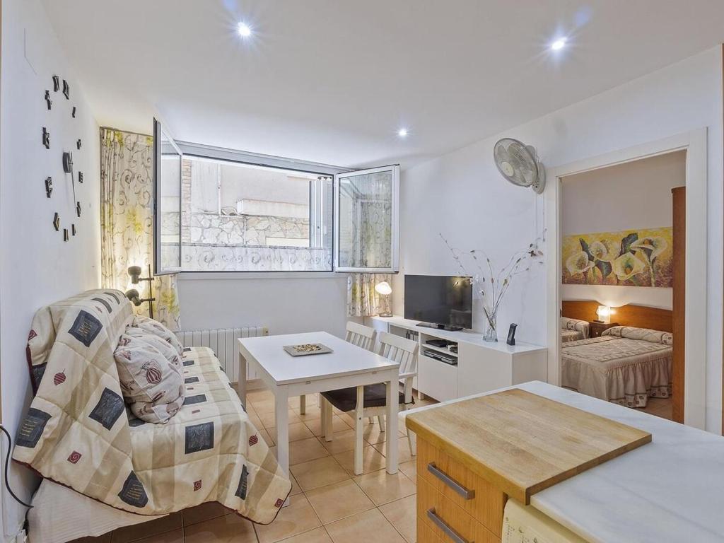 a living room with a couch and a table at Winahost Unió Lloret de Mar in Lloret de Mar