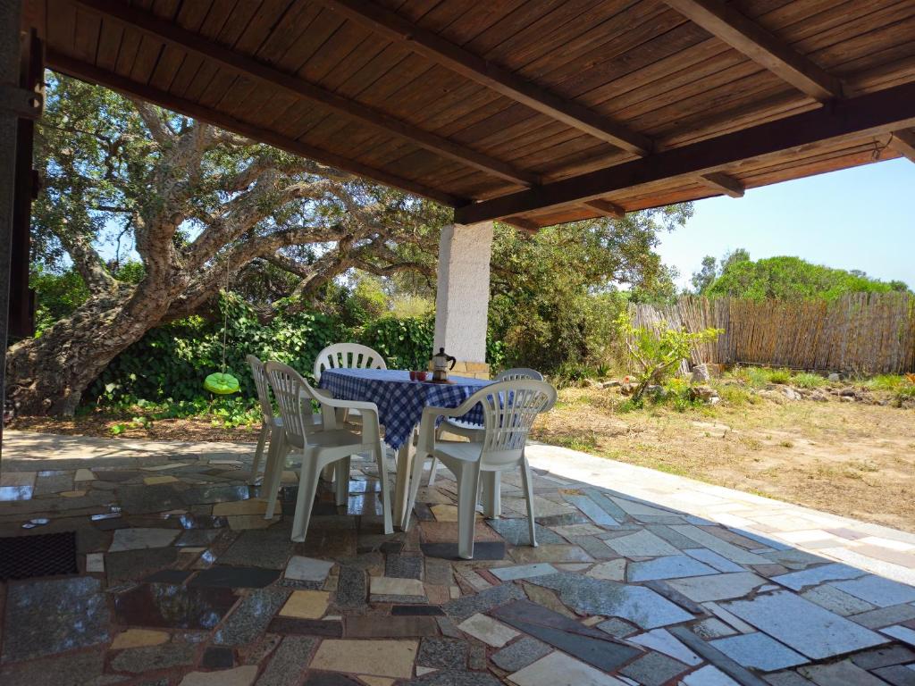 a table and chairs sitting on a patio at Country house La grande quercia in SantʼAntìoco